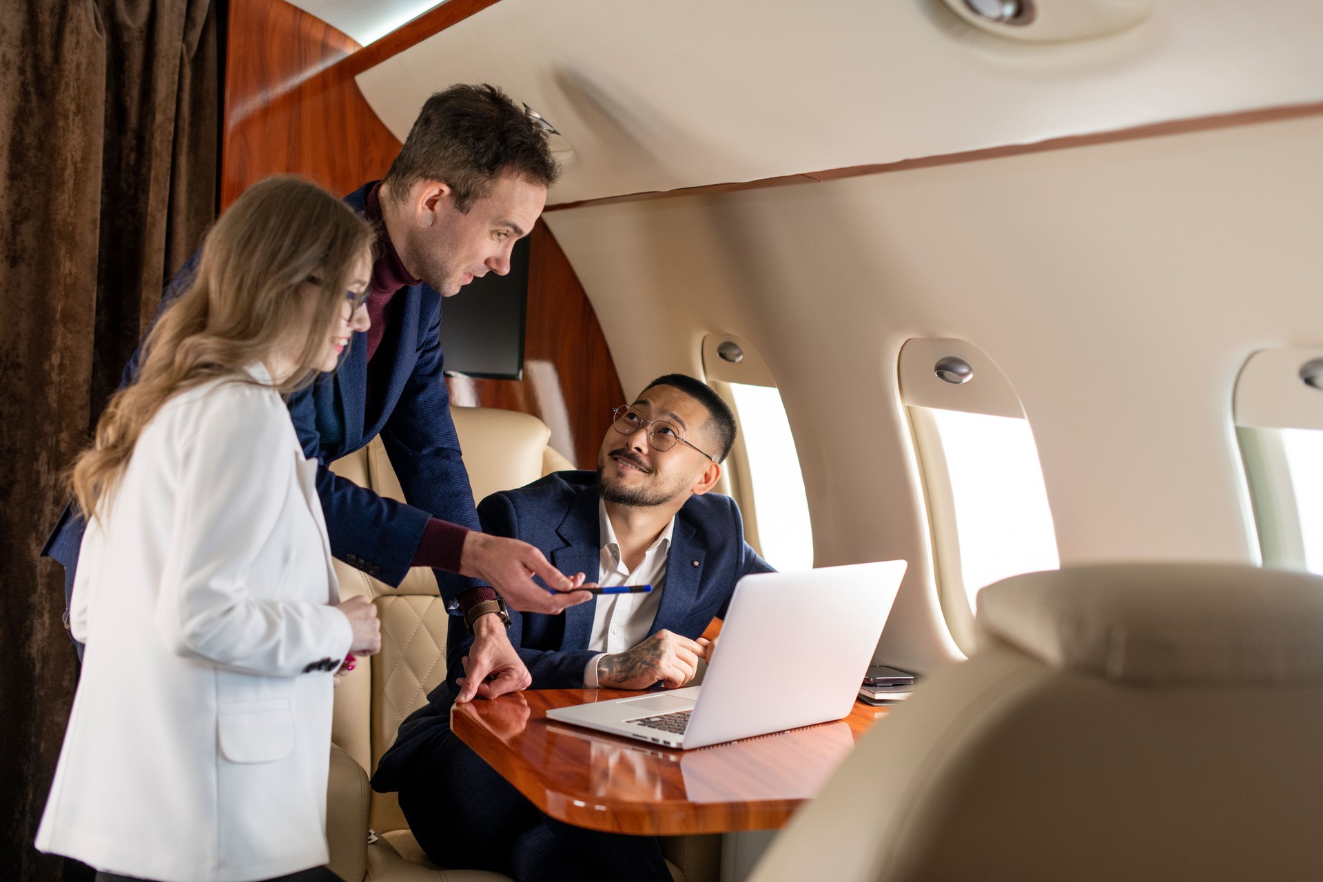 group of people at meeting fly in private jet and discuss business deal, the boss and colleagues in the plane